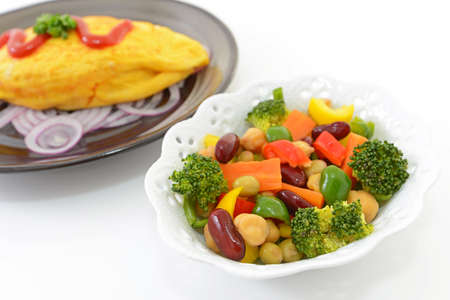 Delicious omelet meal and salad.の写真素材