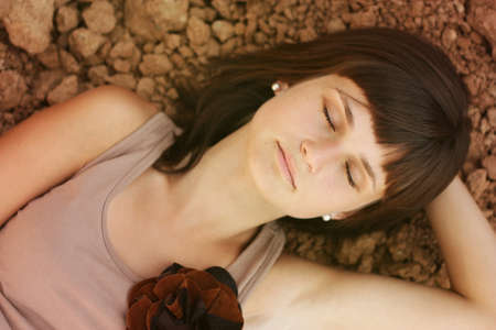 Young beauty girl ralaxing on the ground in summerの写真素材