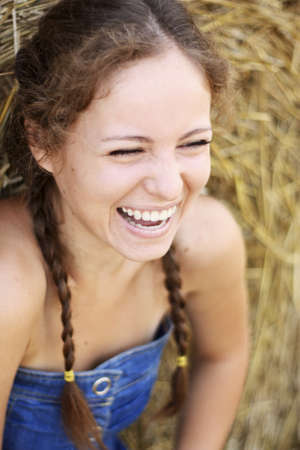Pretty happy healthy young girl laughing in summerの写真素材