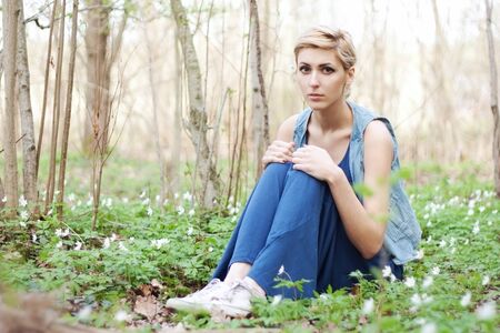 Beautiful girl with flowers in summerの写真素材