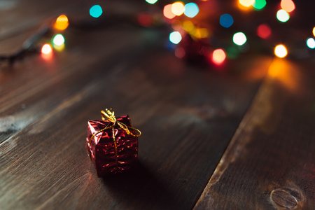 Red small gift with garland lights bokehの写真素材