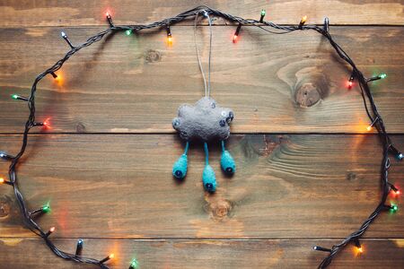 Garland and handmade cloud on the wooden backgroundの写真素材