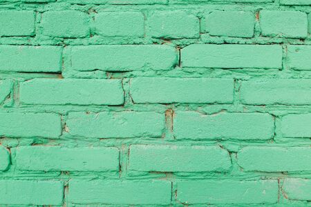 Green painted brick abstract wall backgroundの写真素材
