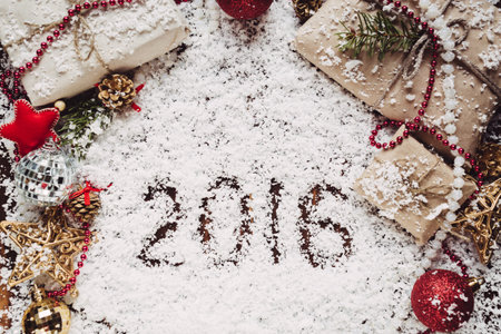 Beautiful Christmas and New year background with presents and decoration on snow table