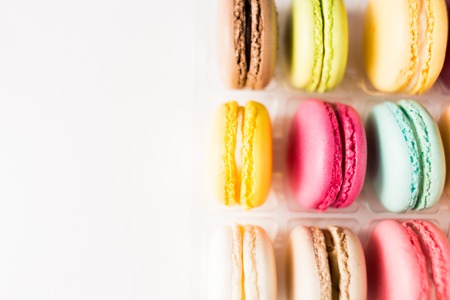 Colored Macarons on white background with copy spaceの写真素材