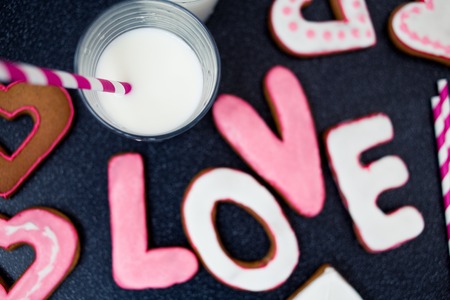 Glass of milk with love letters cookies from top viewの写真素材