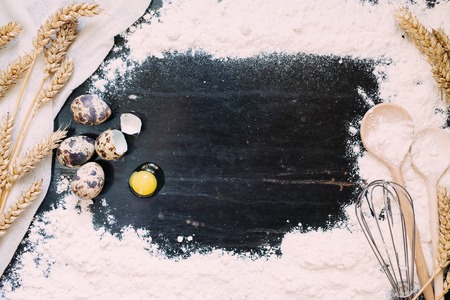 wheat and grain with quail eggs on parchment for bakingの写真素材