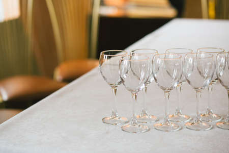 Three empty wineglass on the table with food in the restaurant, copy spaceの写真素材