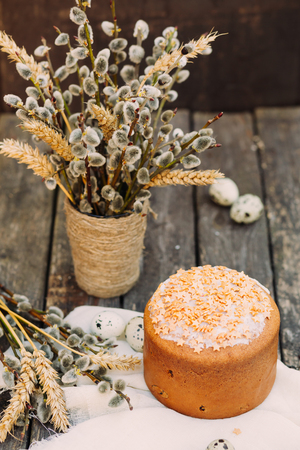 Vase with pussy-willows and wheat ear, sliced Easter cake, selective focus, copy spaceの写真素材