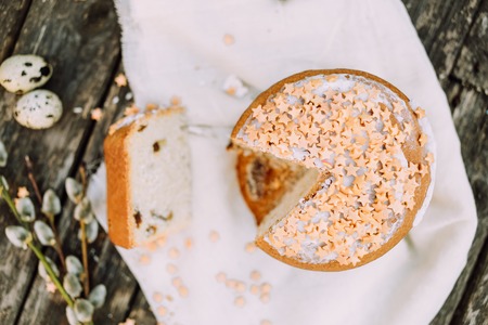 Slice of Easter cake with quail eggs on wooden rustic table, top viewの写真素材