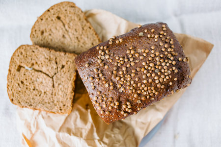 Flavored homemade bread with coriander, rustic background, top view