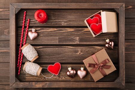 Wooden tray with decorations for Valentine's day, red handmade hearts from felt. Flat lay. Copy space, top viewの写真素材