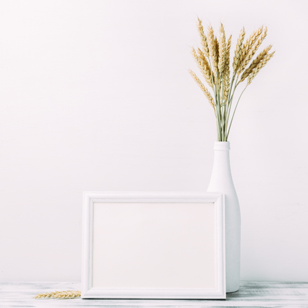 Ripe wheat and empty wooden frameの写真素材
