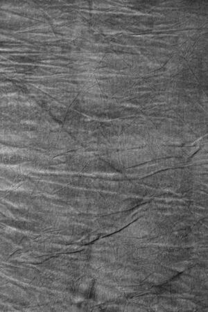 Texture of dark grey crumpled fabricの写真素材