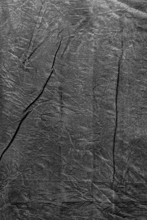 Texture of dark grey crumpled cotton, abstract textile background with copyspaceの写真素材