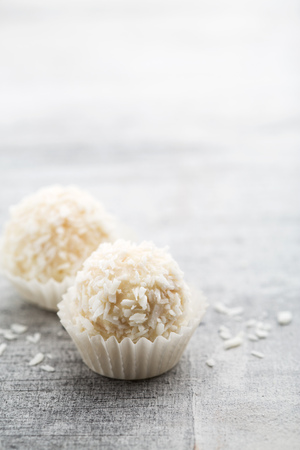 White beautiful coconut candies close up on bright background with copy spaceの写真素材