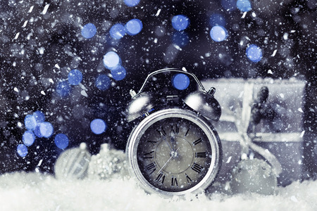 Silver antique alarm clock on blue blurred background. New Year concept, copy spaceの写真素材