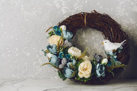 Easter wreath with eggs, blue flowers and little bird. Holiday concept. Copy spaceの写真素材