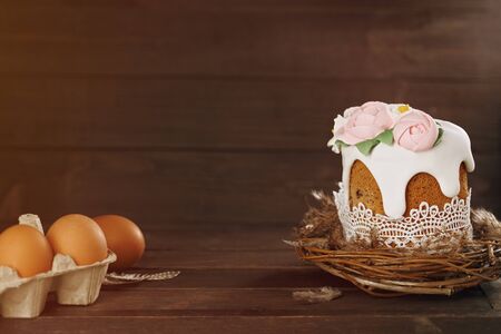 Easter rustic background. Handmade cake in nest with eggs on wooden background. Holiday concept. Happy Easter, copy spaceの写真素材