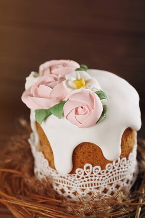 Happy Easter concept. Holiday rustic background. Homemade cake on nest on wooden backgroundの写真素材