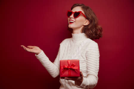 Happy cheerful young woman in knitted sweaterの写真素材