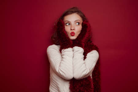 Young woman in knitted sweater send kissの写真素材