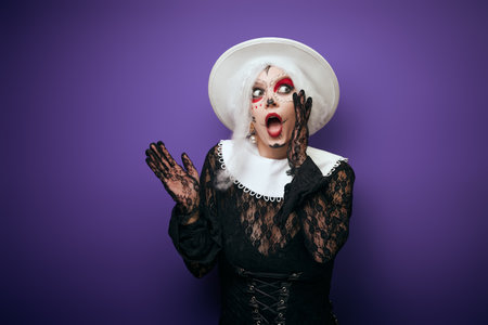 Scared whispering woman with grey hair in Halloween costumeの写真素材