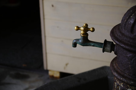 Old faucet in a rural house in the countryside. Selective focus.