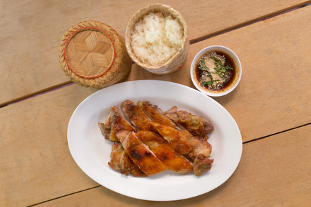 Grilled chicken and rice with sauce in dishの写真素材