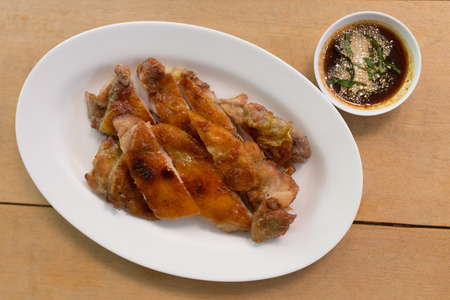 Grilled chicken and sauce in dishの写真素材