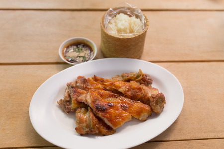 Grilled chicken and rice with sauce in dishの写真素材