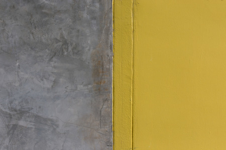 Background of  yellow painted and cement wallの写真素材
