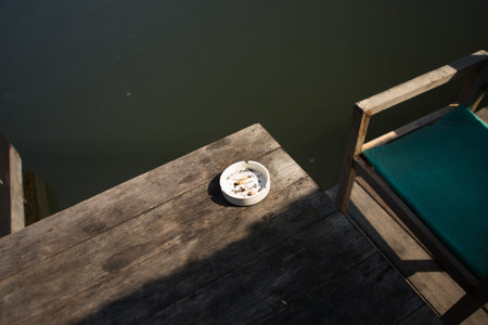 used white ashtray on wood tableの写真素材