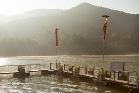 wood bridge on leak in morning , sunlight ,fogの写真素材