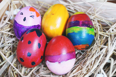 Easter concept, many fancy colorful Easter eggs in wooden nest box