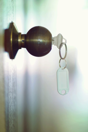 House key with home keyring in keyhole, property concept, empty tag