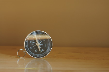 Compass on blur colorful photograph of popular toustist destination background, China traveling conceptの写真素材