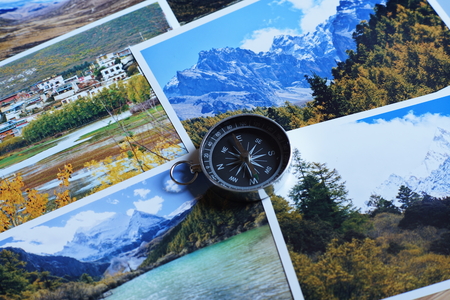 Compass on blur colorful photograph of popular toustist destination background, China traveling conceptの写真素材