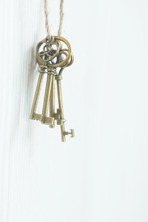 Vintage keys hanging on wall, key concept, copy spaceの写真素材