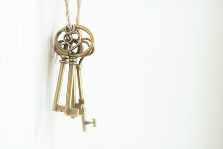 Vintage keys hanging on wall, key concept, copy space