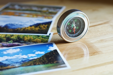 Compass on blur colorful nature photograph of popular tourist destination in autumn background, China traveling conceptの写真素材