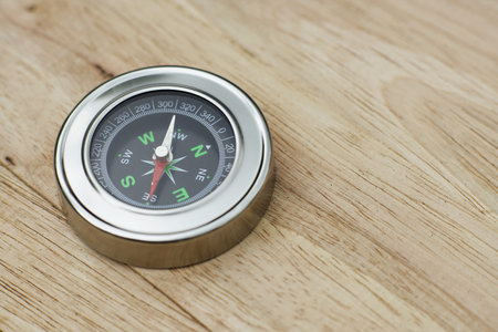 Compass on wooden table, journey concept, copy space