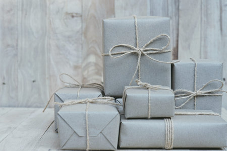 Eco friendly gift boxes wrapped with brown paper, green happy new year present concept, copy space