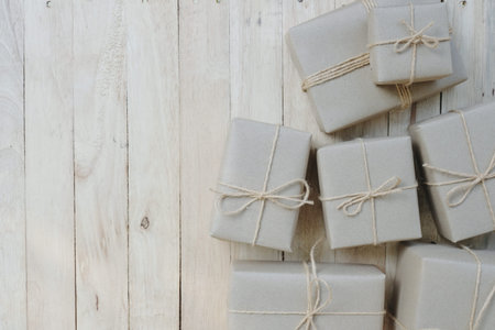 Eco friendly gift boxes wrapped with brown paper, green happy new year present concept, copy space