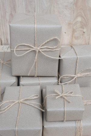 Eco friendly gift boxes wrapped with brown paper, green happy new year present concept, copy space