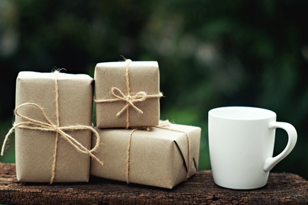 Simple eco friendly gift boxes package wrap with brown paper on vintage wooden table, green present concept, copy spaceの写真素材