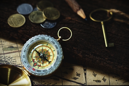 Vintage tone compass, coin, key and map, antique travel concept, copy spaceの写真素材