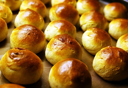 Golden wheat buns freshly baked, straight from the ovenの写真素材