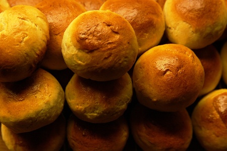 Golden wheat buns freshly baked, straight from the ovenの写真素材