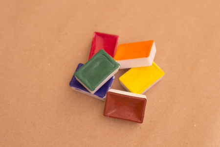 Abstract figure photography for editors, designers and artists with little water colour bricks on yellow design paperの写真素材